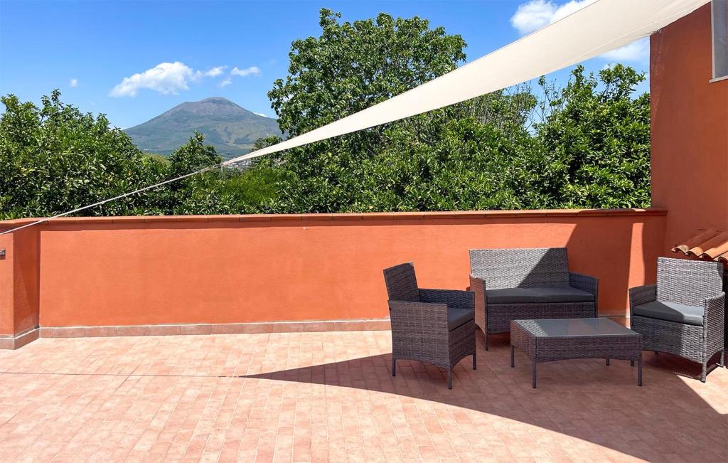 a patio with chairs and a table with a view at L'agrumeto in Pompei