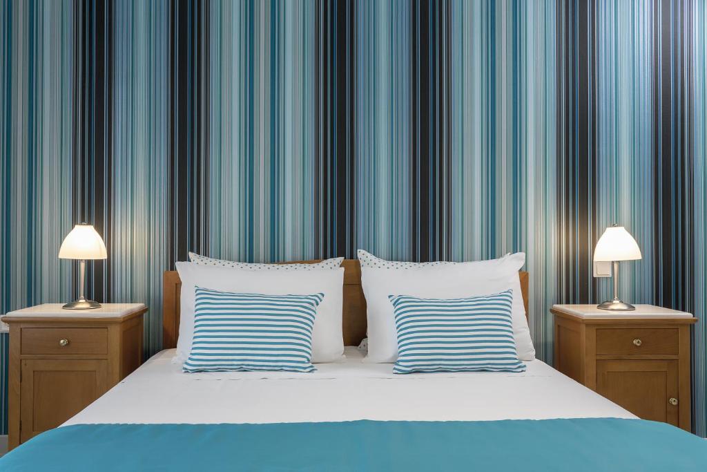 Postel nebo postele na pokoji v ubytování Santellini Hotel