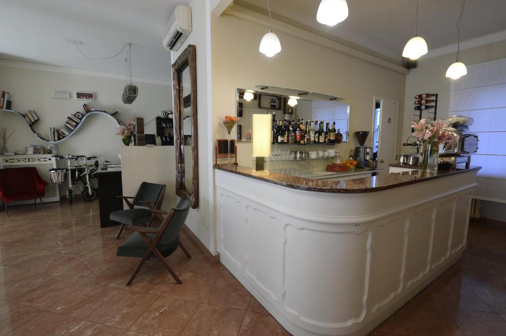 a bar in a room with a counter and chairs at Hotel Tourist in Turin
