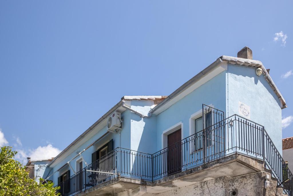 a blue building with a balcony at B&B La Casa di Carolina in Maratea