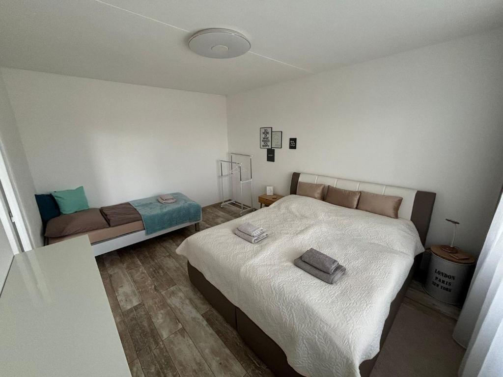 a small bedroom with a bed and a couch at Apartmán Radvaň in Banská Bystrica
