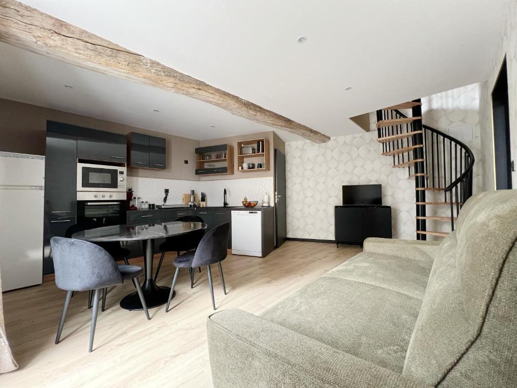 un salon et une cuisine avec un canapé et une table dans l'établissement Gîte Le 240b, à Saint-Mard