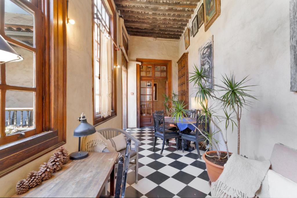 a living room with a table and a checkered floor at Casa Montesdeoca - Jacaranda in Las Palmas de Gran Canaria