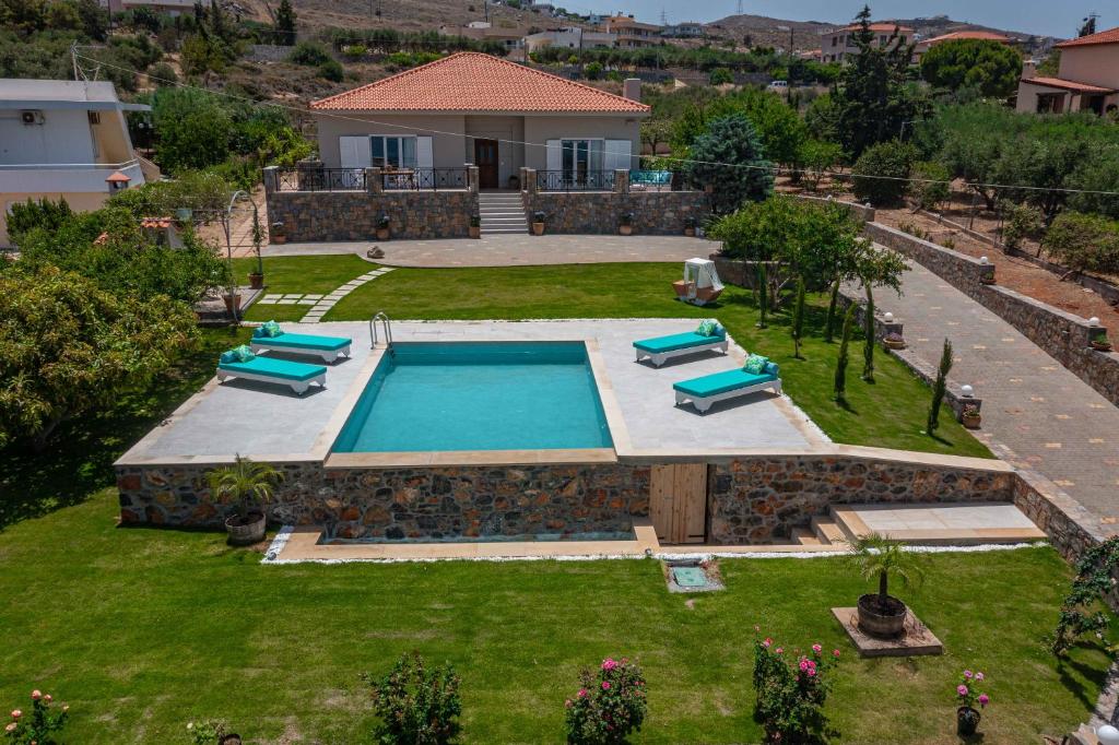 an aerial view of a backyard with a swimming pool at Villa Manetti with Private Pool and Garden by Hospi in Kokkíni Khánion
