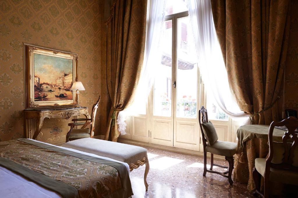 Postel nebo postele na pokoji v ubytování Palazzo Paruta & Wellness Suites