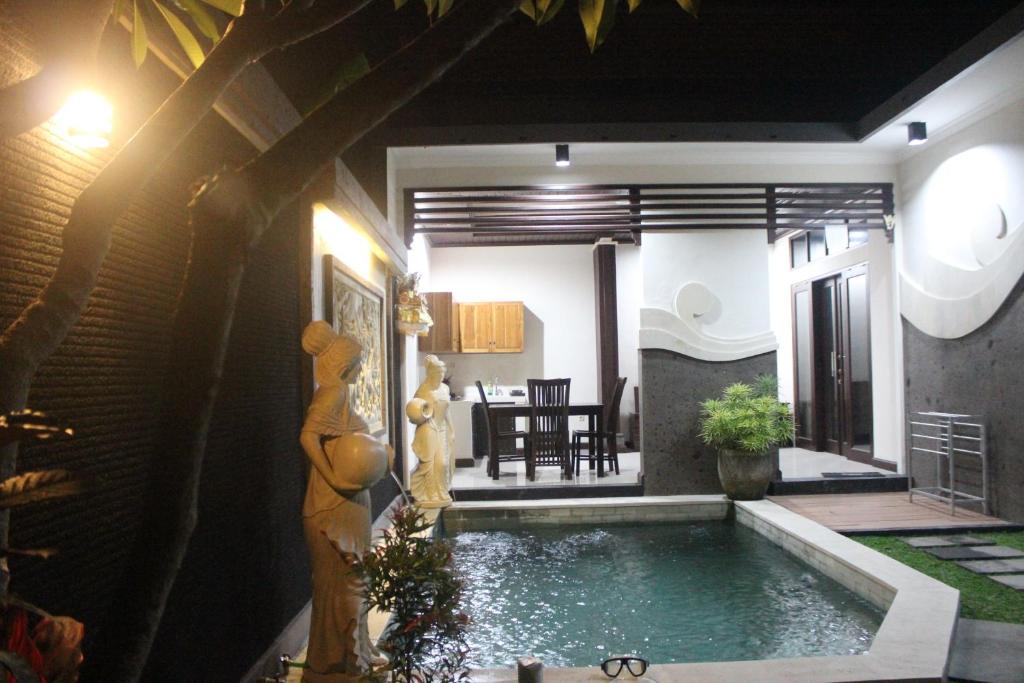 a swimming pool in the middle of a house at Alit Bali Villa in Canggu