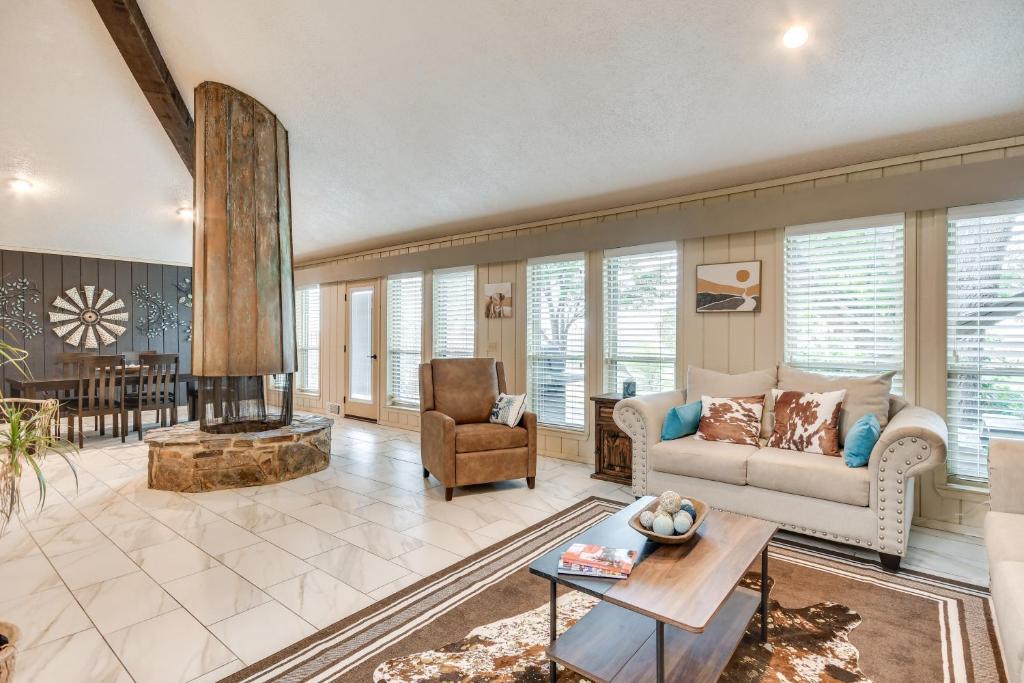 a living room with a couch and a fireplace at Remote Texas Retreat Hot Tub, Deck, Grill! in Dalhart
