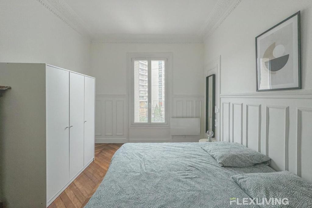 a white bedroom with a bed and a window at Flexliving - Room - Henri Sellier - Suresnes 92 in Suresnes