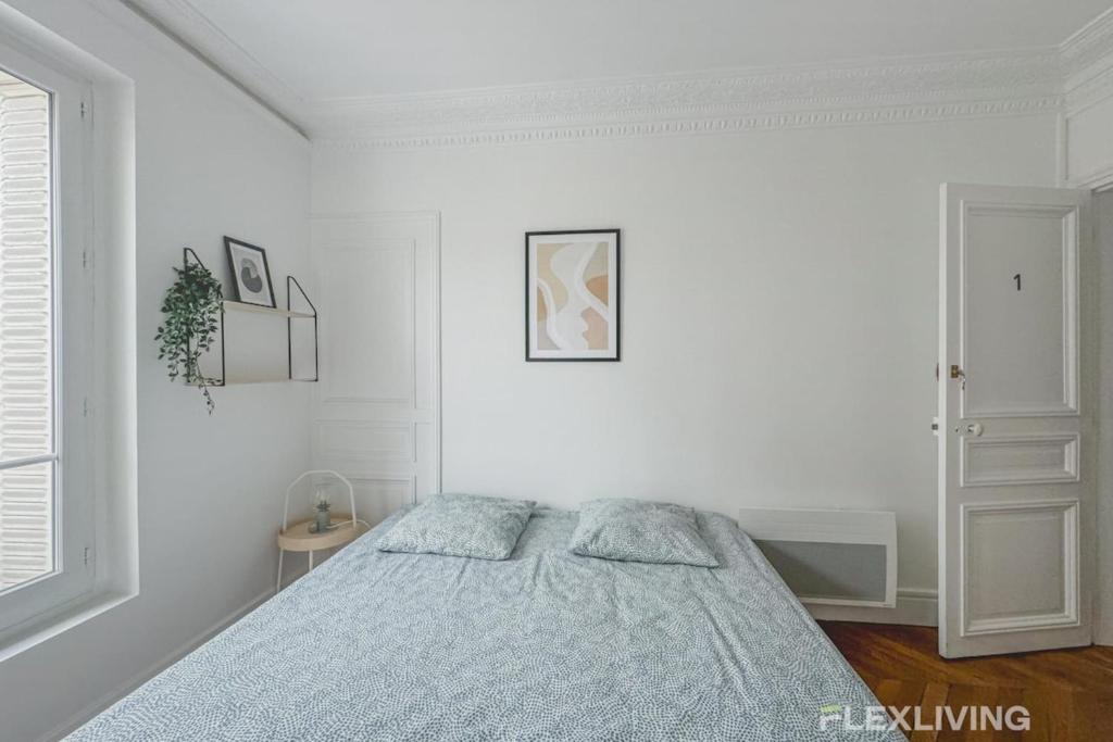 a white bedroom with a bed and a window at Flexliving - Room - Henri Sellier - Suresnes 92 in Suresnes