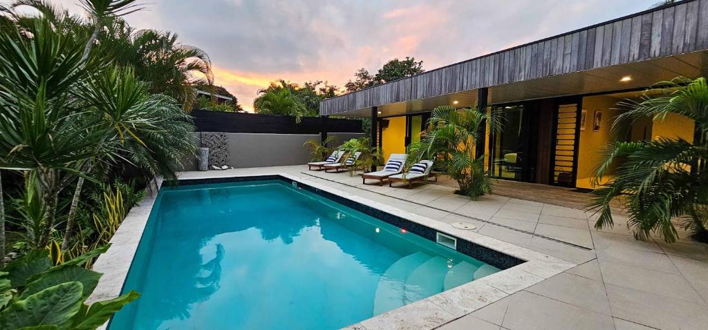 a swimming pool in the backyard of a house at Pacific Palms Luxury Villa in Rarotonga