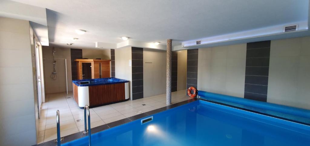 a swimming pool in a bathroom with a tub at MANDARA WELLNES APARTMANOK in Siófok