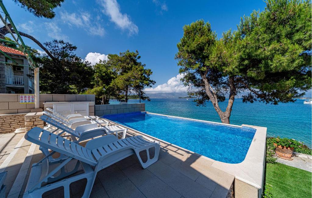 basen z leżakami nad wodą w obiekcie Apartment Koludrt Bb Croatia w mieście Lumbarda
