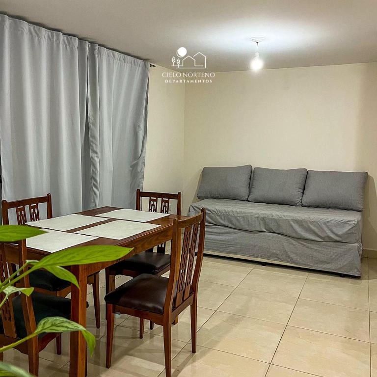 a living room with a table and a couch at Cielo Norteño in San Salvador de Jujuy