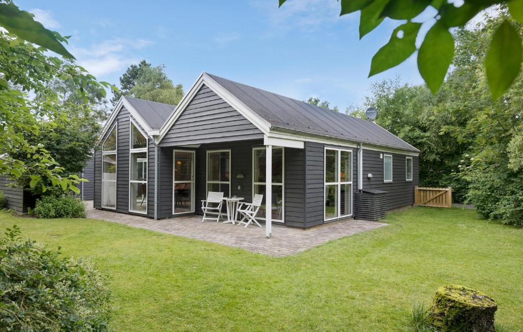 una casa negra con patio en Amazing Home In Farsø With Sauna, en Farsø