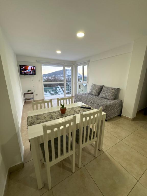 a living room with a table and chairs and a couch at Rincón Montañas del Sur in Ushuaia