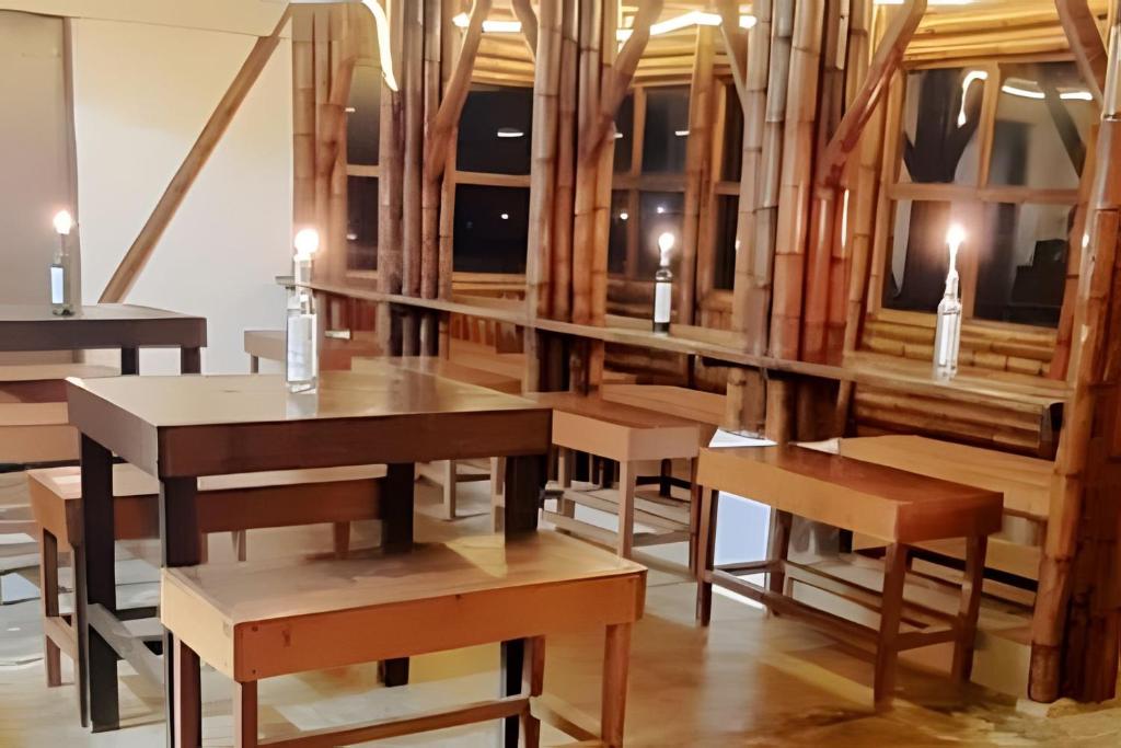 a dining room with wooden tables and benches at Club Cean in Madroñal