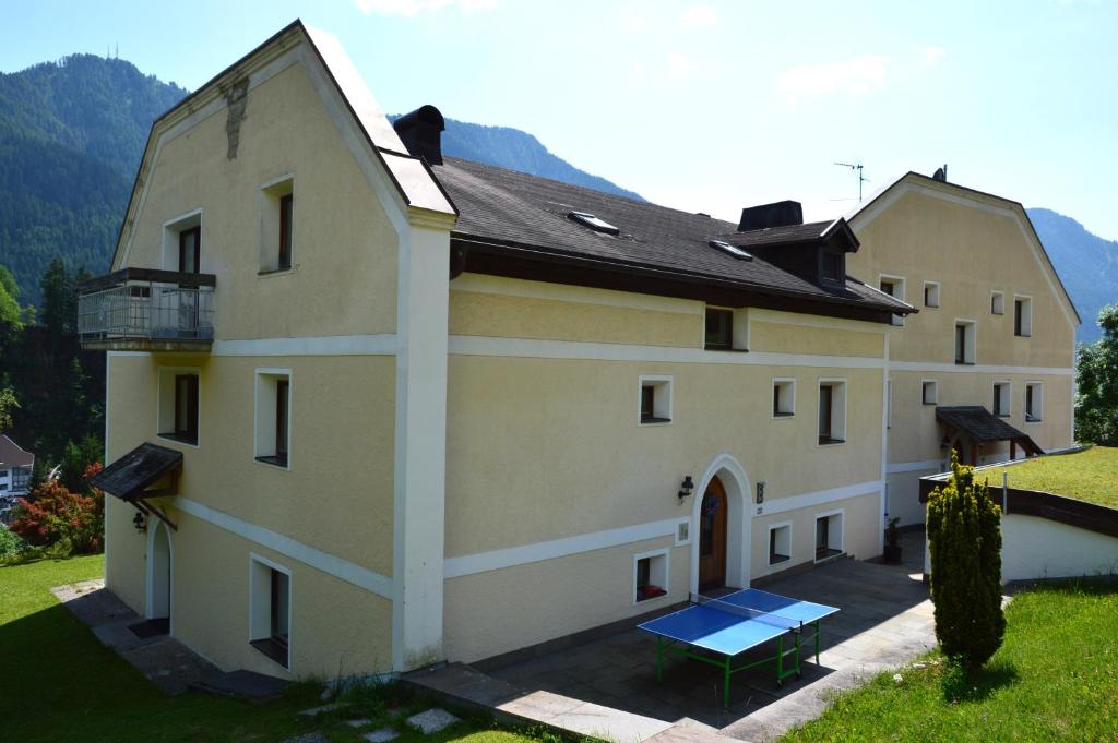 a large building with a picnic table in front of it at Residence Granvara in Ortisei