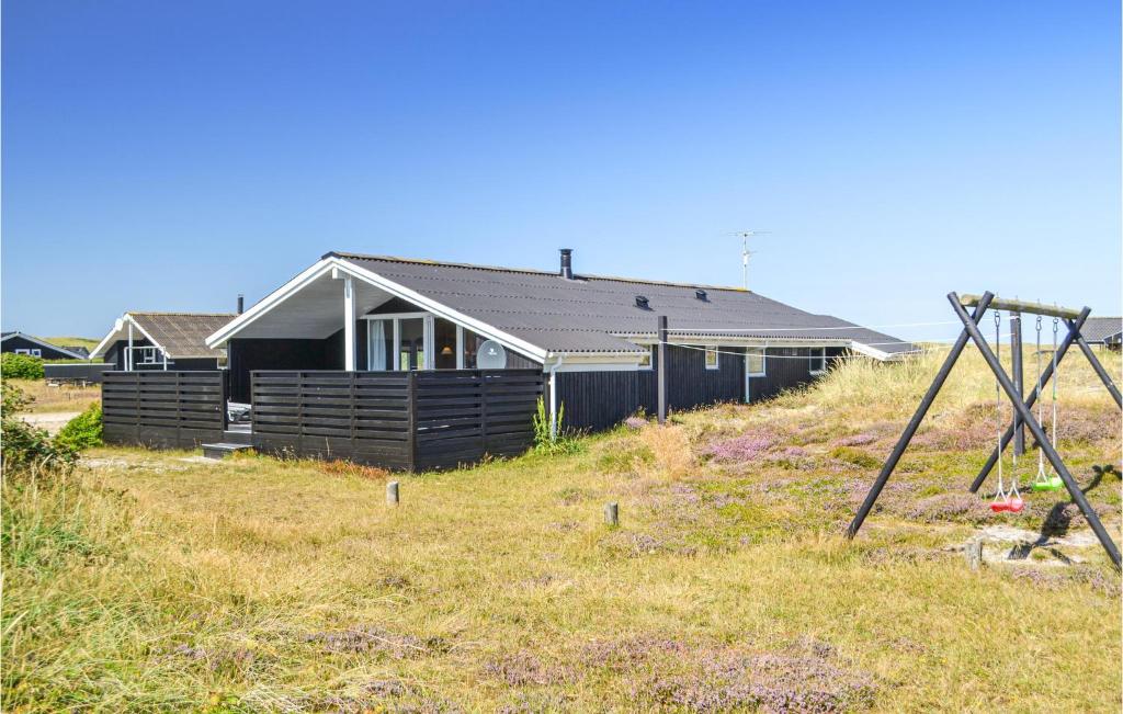 a house sitting on top of a grassy hill at Holiday Home Arvidvej Iv in Bjerregård