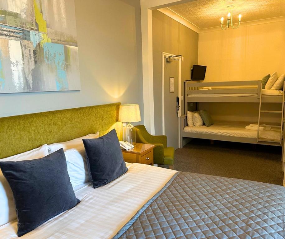 a bedroom with a bed with blue pillows at The Cliff Hotel & Spa in Cardigan