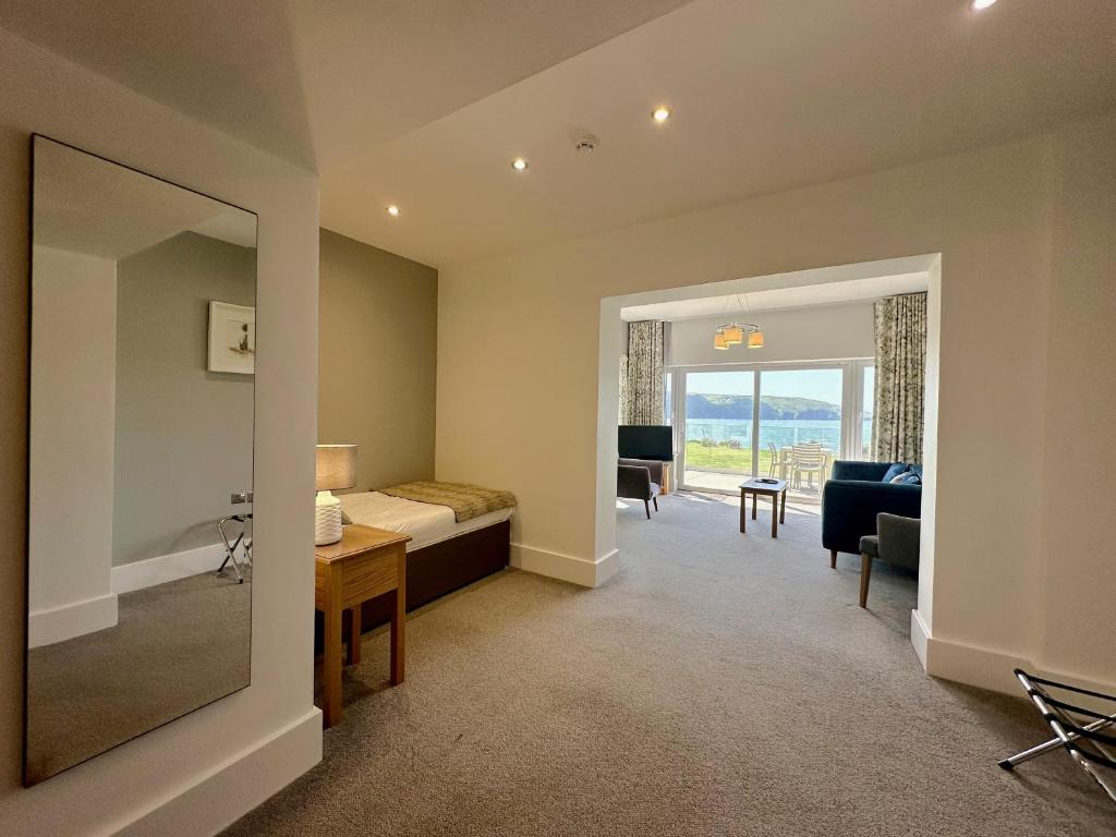 a bedroom with a bed and a desk in a room at The Cliff Hotel & Spa in Cardigan