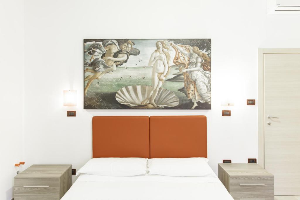 Un pat sau paturi într-o cameră la IN FIERA 5 appartmento