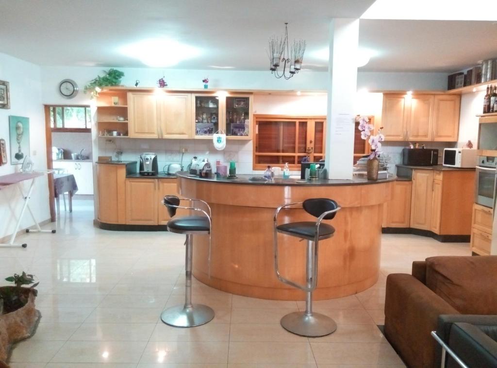 a kitchen with a large island in the middle of a room at Castel Ashkelon in Ashqelon