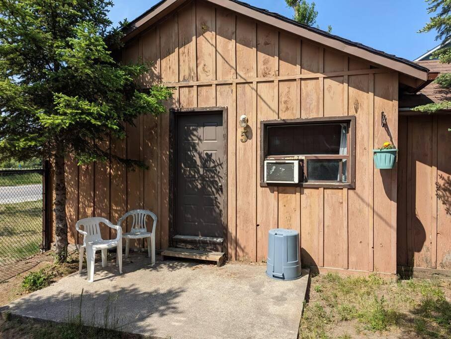 a shed with a table and chairs in front of it at Tiny Wood Cottage 05 in Wasaga Beach