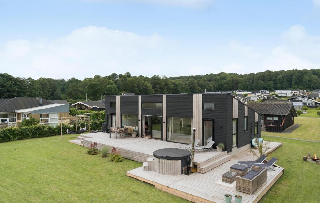an aerial view of a house with a deck at 4 Bedroom Gorgeous Home In Sjølund in Sjølund