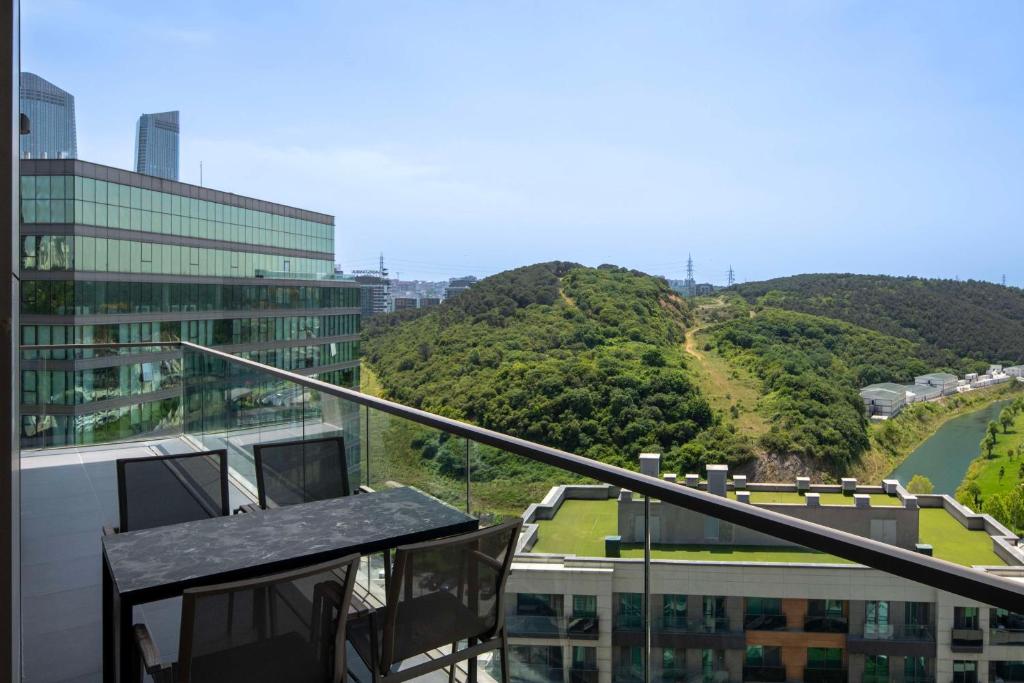 a balcony of a building with a view of a mountain at Radisson Residences Vadistanbul in Istanbul