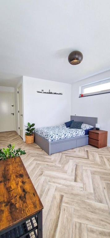a bedroom with two beds and a wooden floor at Modern & Convenient Studio in Arnhem