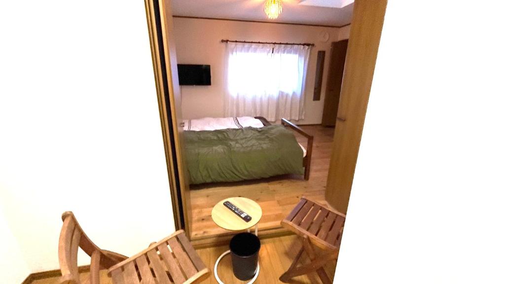 Postel nebo postele na pokoji v ubytování サンルームふじさん