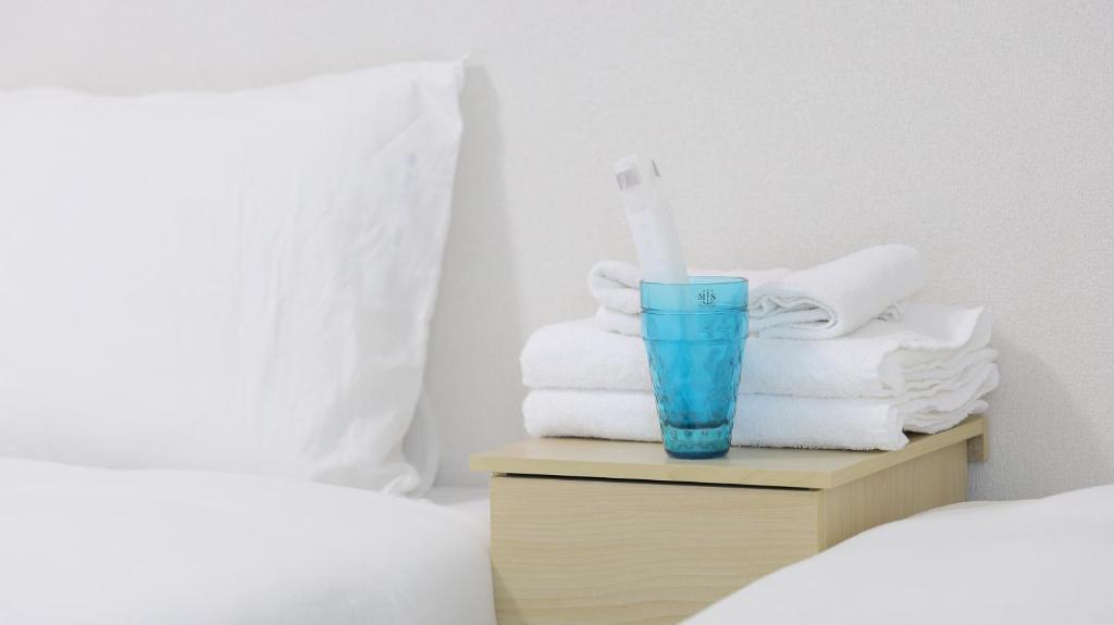 Postel nebo postele na pokoji v ubytování Ayanishiki大阪西九条STAY