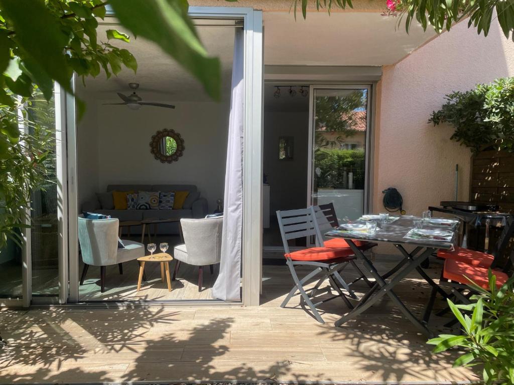 un patio avec une table, des chaises et un canapé dans l'établissement Appartement rénové avec jardin à 5 min de la plage - 4 pers, garage inclus - FR-1-309-392, à Argelès-sur-Mer