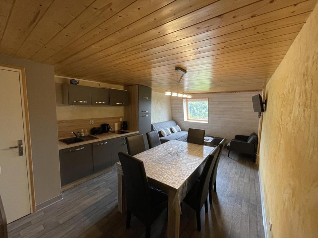 a kitchen and dining room with a table and chairs at Beau duplex 6 pers. à 200m des pistes, parking gratuit - FR-1-787-11 in Saint-Jacques-des-Blats
