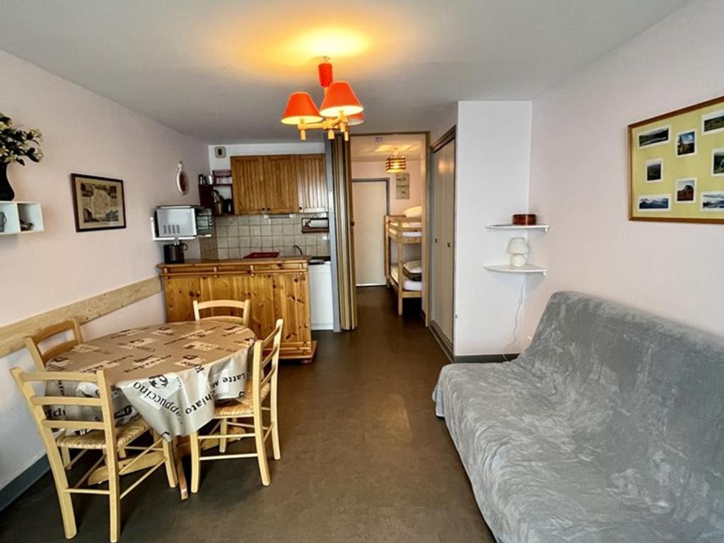 - une cuisine et une salle à manger avec une table et un canapé dans l'établissement Studio cosy avec terrasse ensoleillée - FR-1-787-26, à Laveissière