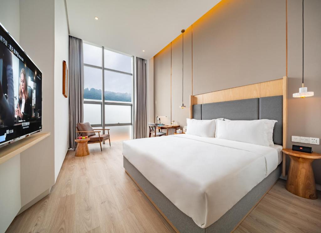 Postel nebo postele na pokoji v ubytování Wuyu Hotel - Chongqing Liangjiang Happiness Plaza & Xingfu Square & GuangdianYuan metro