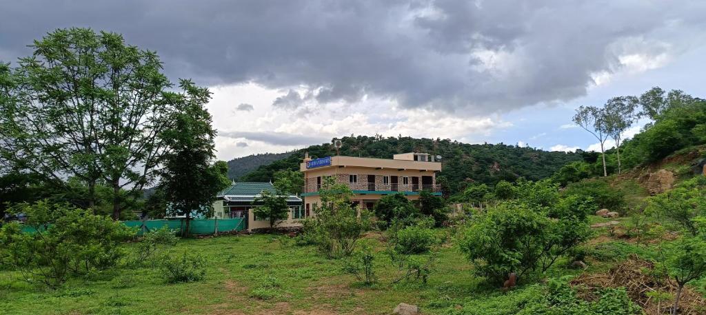 a house on the side of a hill at Sathyam Resorts in Dharmapuri