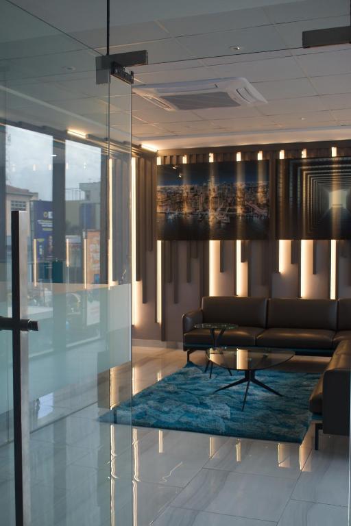 a living room with a couch and a table at Bankable Roomzzz in Accra