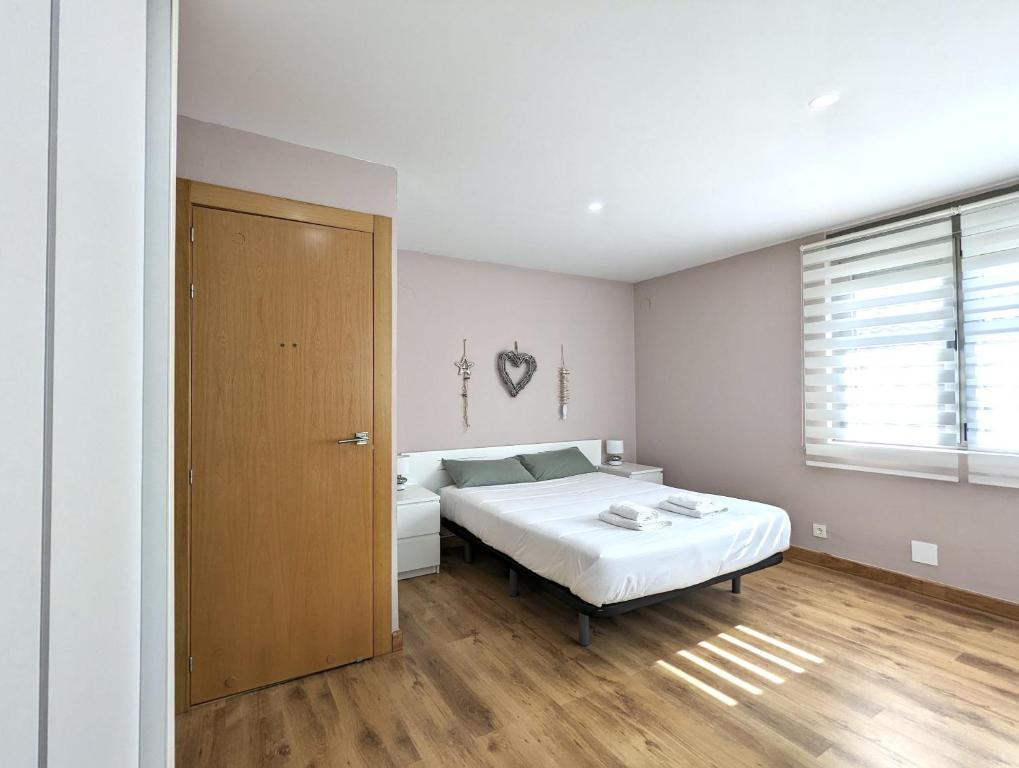 Schlafzimmer mit einem Bett und einer Holztür in der Unterkunft Casa moderno en Renedo de Pielagos in Renedo de Piélagos