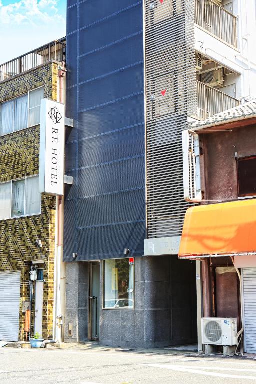 a building with a sign on the side of it at RE Hotel 谷町9丁目 in Osaka