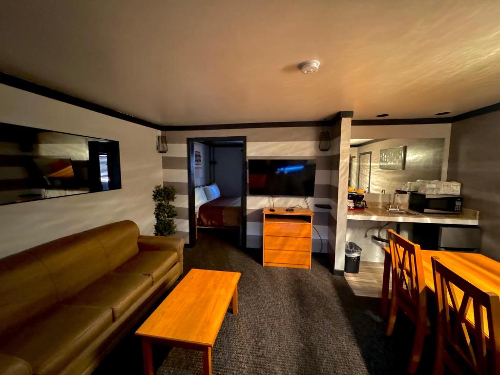 a living room with a couch and a table and a bed at Cascade Lodge in Bend