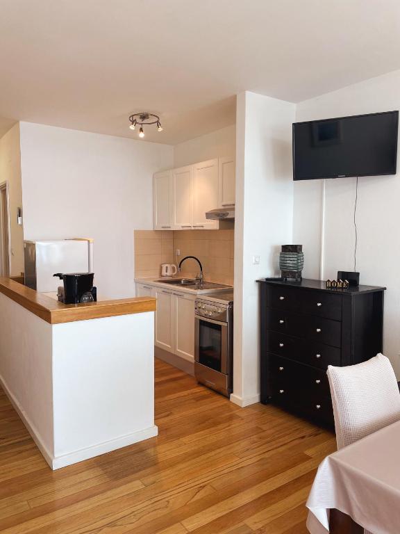 a kitchen with white cabinets and a counter top at Prizba Tomas One in Blato