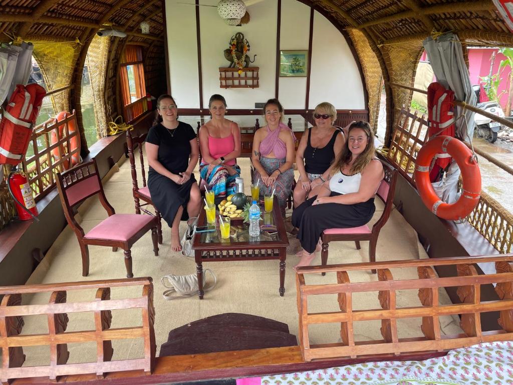 a group of women sitting in a room at Thara's Houseboat in Alleppey