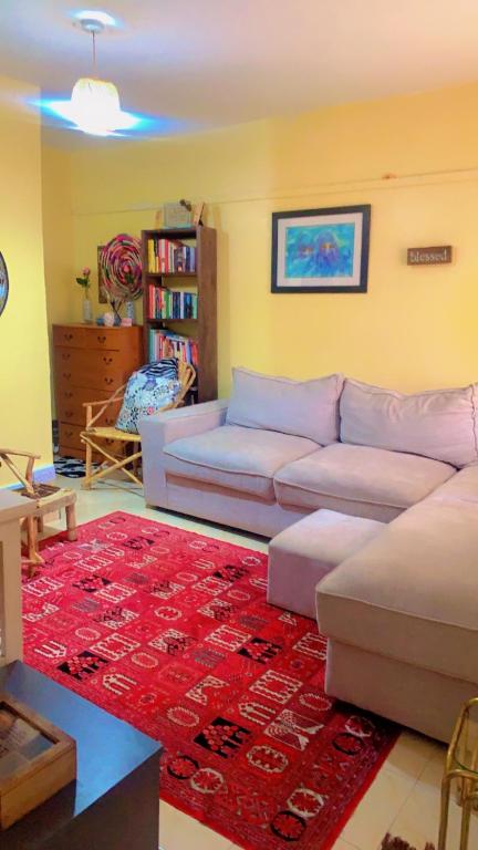 a living room with a couch and a red rug at 7 Mogotio in Nairobi