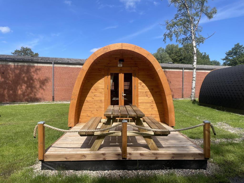 a small wooden structure with a chain around it at 44 Camping Pod in Silberstedt