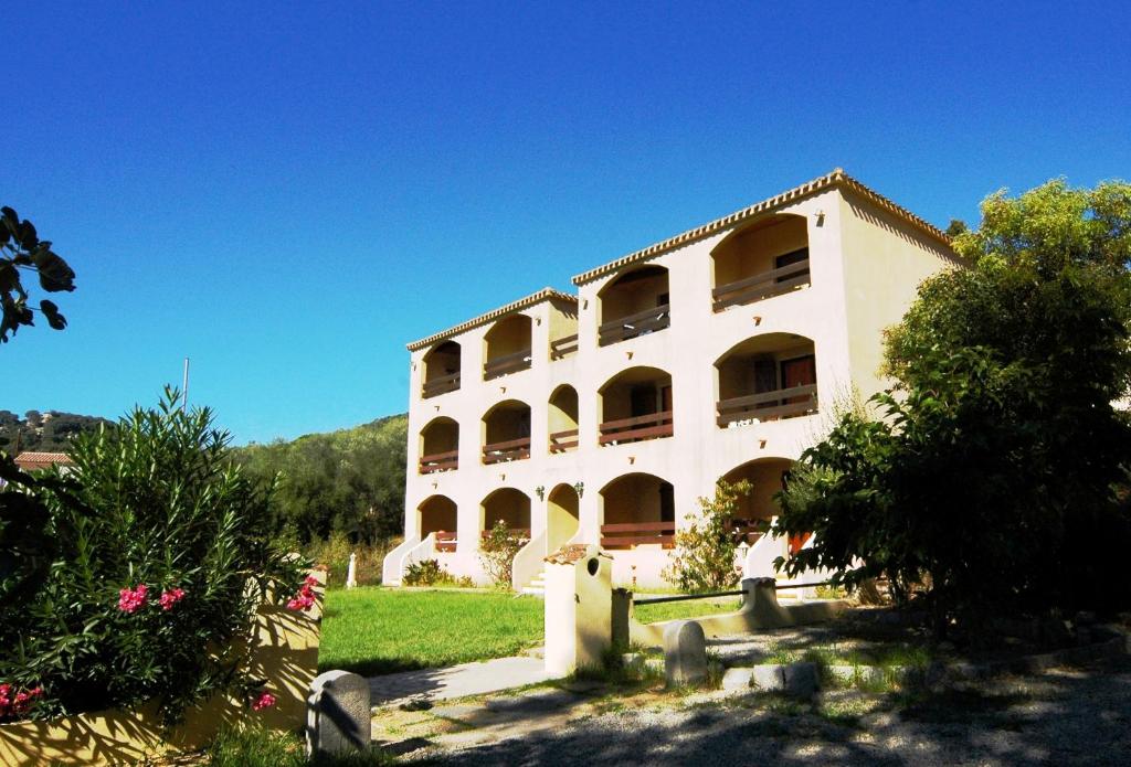 a large white building with a lot of windows at Residence I Delfini in Tiuccia