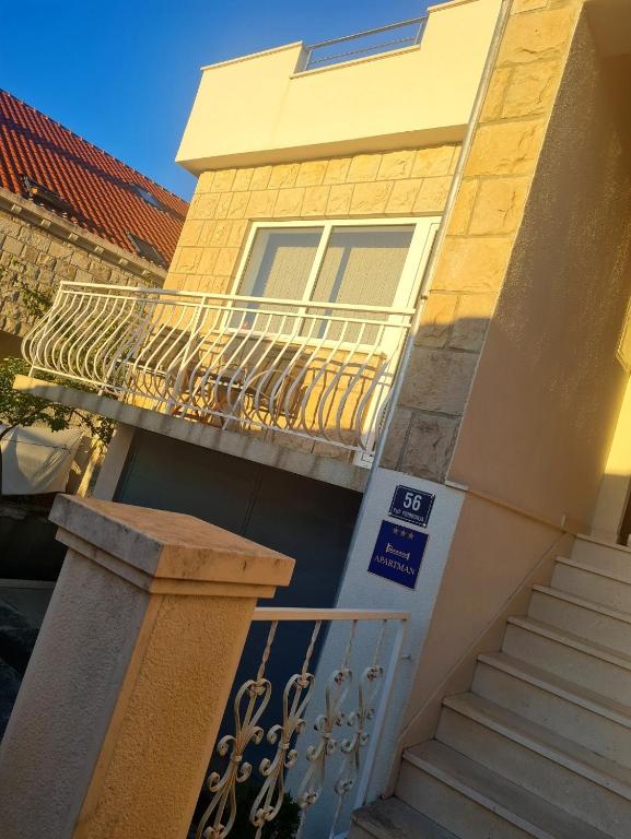 a building with a balcony and a staircase at Antonny apartment in Zvekovica