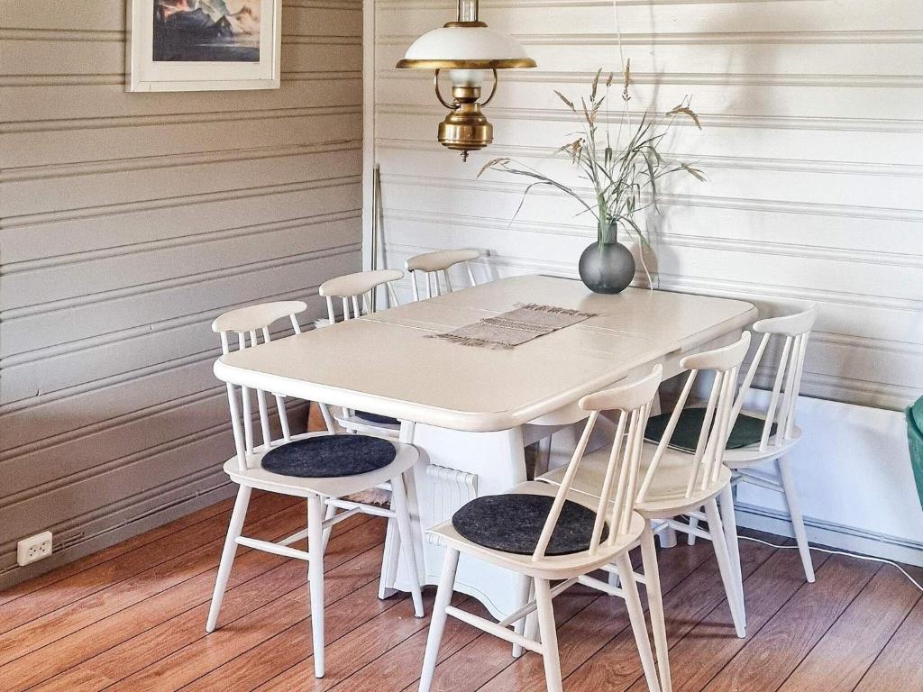 a white table and chairs in a room at 6 person holiday home in Flatanger in Lauvsnes