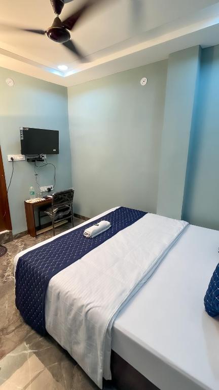 Postel nebo postele na pokoji v ubytování Hotel Abhinanadan