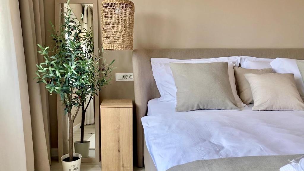 a bedroom with a bed with white sheets and pillows at Up&Above ,New Luxury Apt, Steps from Beach and Old Town in Hvar